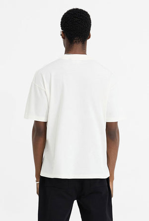 Back image of a model wearing the Initial oversized t in off white, by brand Represent