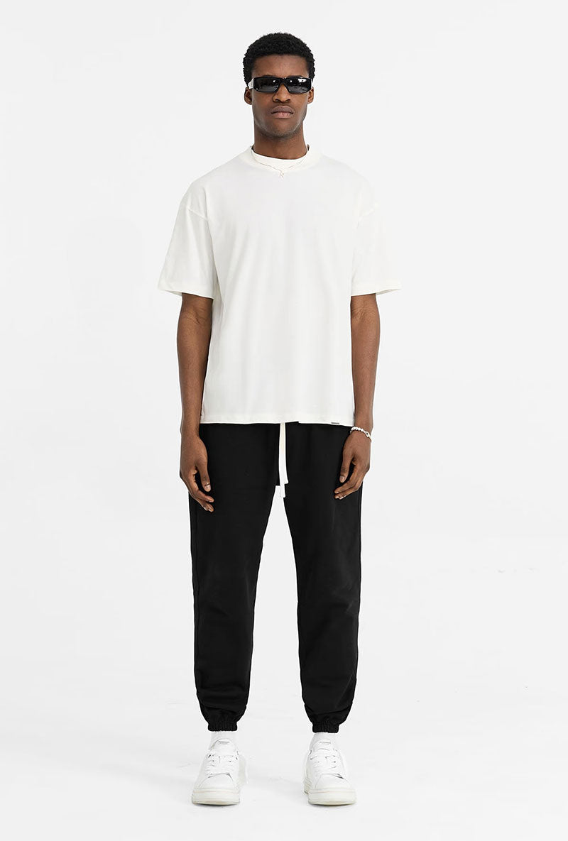 Front image of a model wearing Initial oversized t in off white, by brand Represent