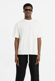 Front image of a model wearing the Initial oversized t in off white, by brand Represent