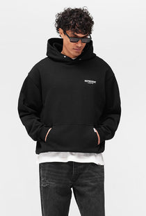 Front image of a model wearing the Owners club hoodie in black, by brand Represent