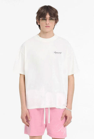 Front image of a model wearing the Owners club script t in off white, by brand Represent