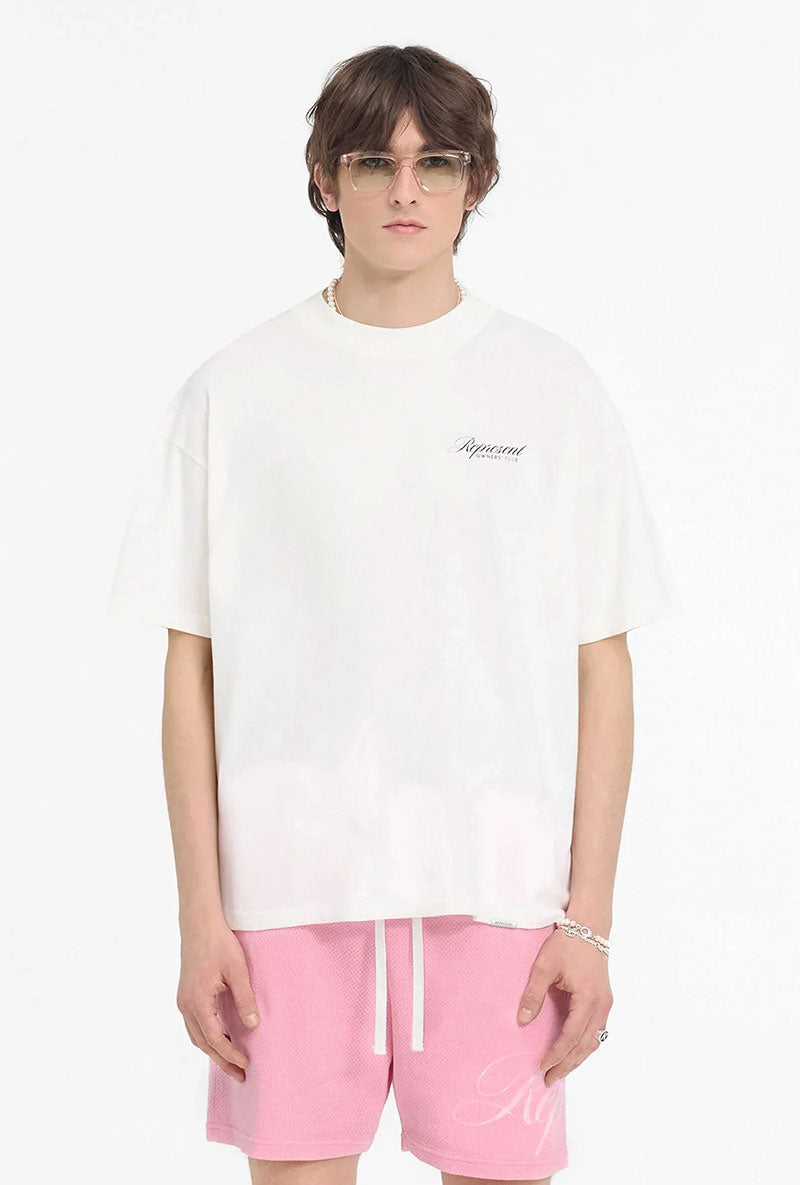 Front image of a model wearing Owners club script t in off white, by brand Represent