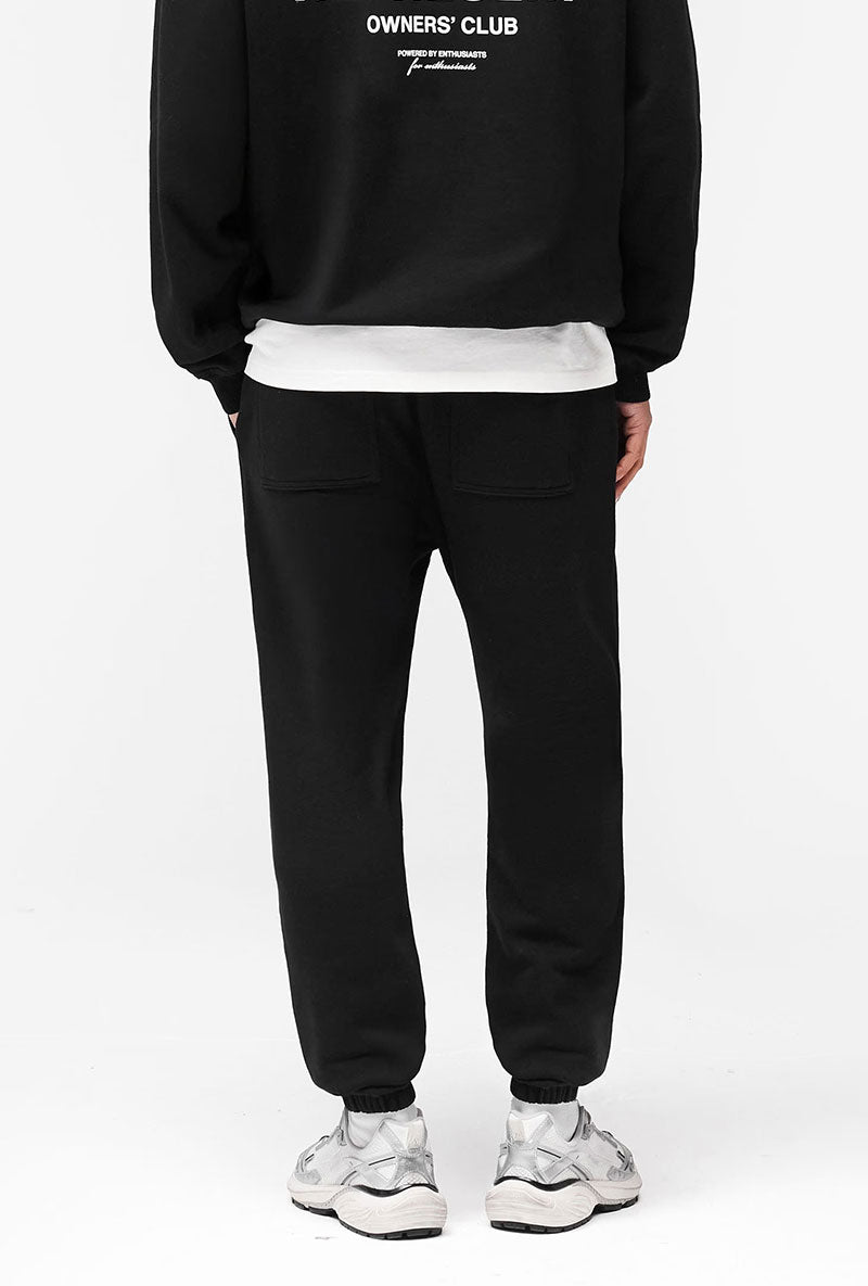 Back image of a model wearing Owners club sweatpant in black, by brand Represent