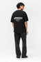 Back image of a model wearing the Owners club t in black, by brand Represent