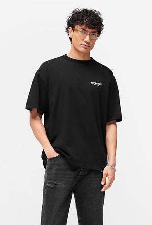 Front image of a model wearing the Owners club t in black, by brand Represent