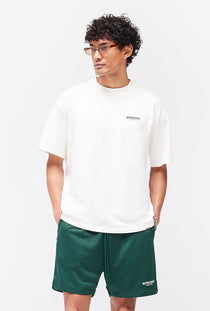 Front image of a model wearing the Owners club t in off white, by brand Represent