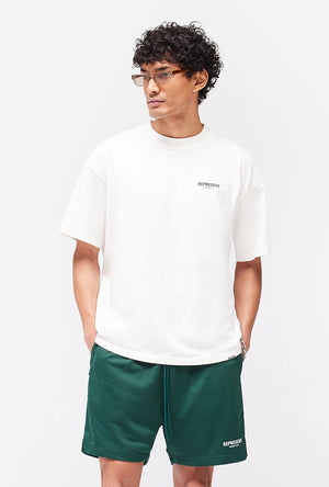 Front image of a model wearing the Owners club t in off white, by brand Represent