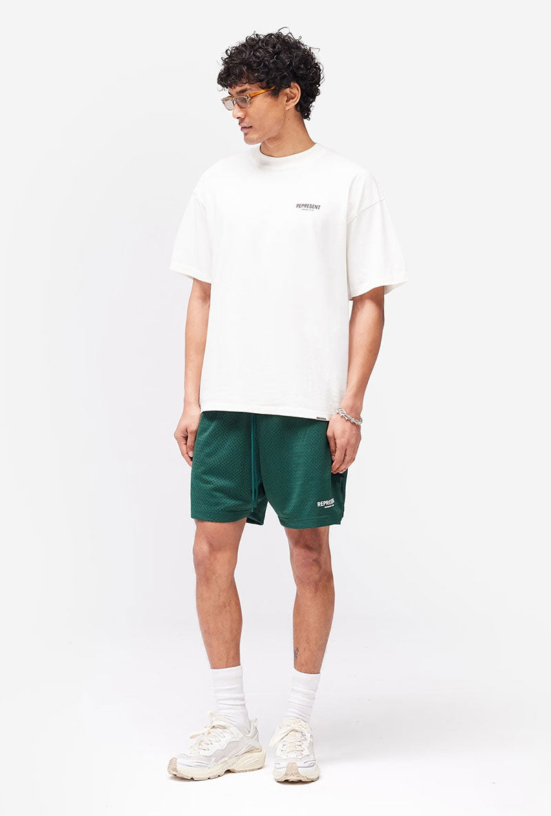 Front image of a model wearing Owners club t in off white, by brand Represent