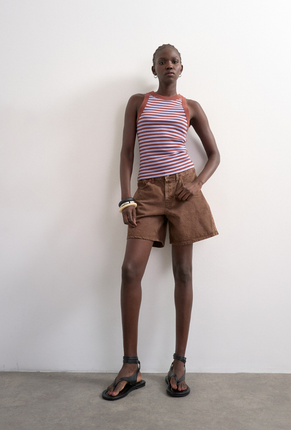 Front image of a model wearing Sanne rib racer vest in chcolate, by brand Top shop
