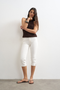 Front image of Camilla highrise denim capri in white, by brand Top shop