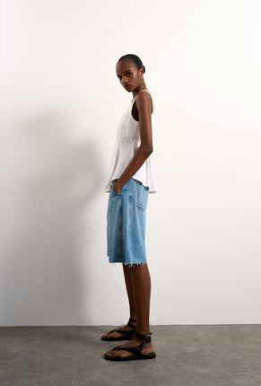 Front image of Mariam sleeveless curve hem top in white, by brand Top shop
