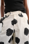 Front image of the Yara highrise dot barrel trousers in white, by brand Top shop