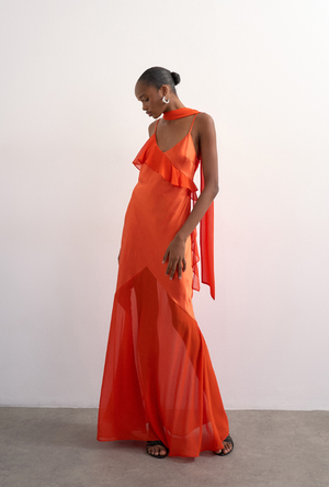 Front image of a model wearing the Annika ruffle maxi dress in rust, by brand Top shop
