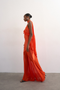 Front image of a model wearing the Annika ruffle maxi dress in rust, by brand Top shop