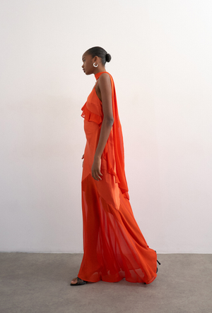 Front image of a model wearing the Annika ruffle maxi dress in rust, by brand Top shop