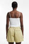 Back image of a model wearing the Eva a line shorts in sage, by brand Top shop