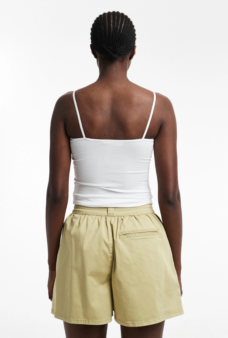 Back image of a model wearing Eva a line shorts in sage, by brand Top shop