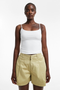 Front image of a model wearing Eva a line shorts in sage, by brand Top shop