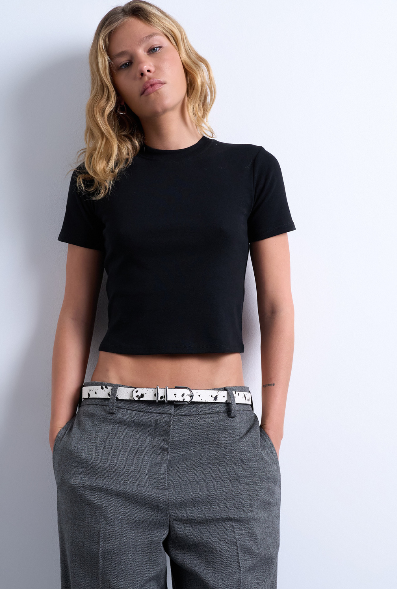 Front image of a model wearing Everyday crop top in black, by brand Top shop