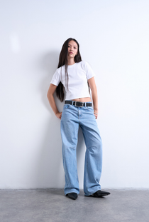 Front image of a model wearing the Everyday crop top in white, by brand Top shop