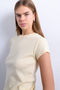Front image of a model wearing the Everyday top in yellow, by brand Top shop