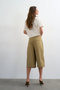 Back image of a model wearing the Femke longline cargo shorts in tan, by brand Top shop