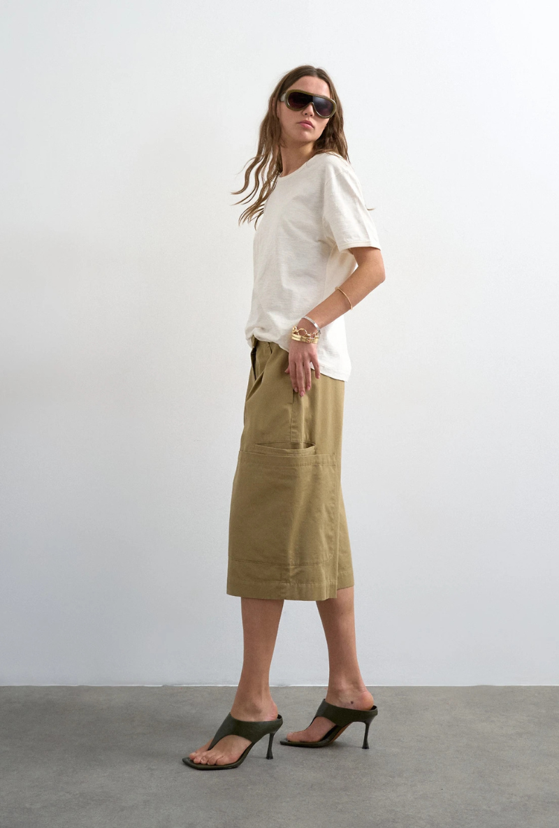 Front image of a model wearing Femke longline cargo shorts in tan, by brand Top shop