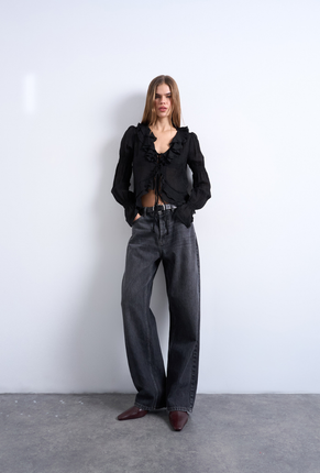 Front image of a model wearing Fiona ruffle top in black, by brand Top shop