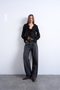 Front image of a model wearing Fiona ruffle top in black, by brand Top shop