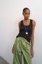 Front image of a model wearing the Honey vest in black, by brand Top shop