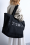 Back image of a model wearing the Ivy tote bag in black, by brand Top shop