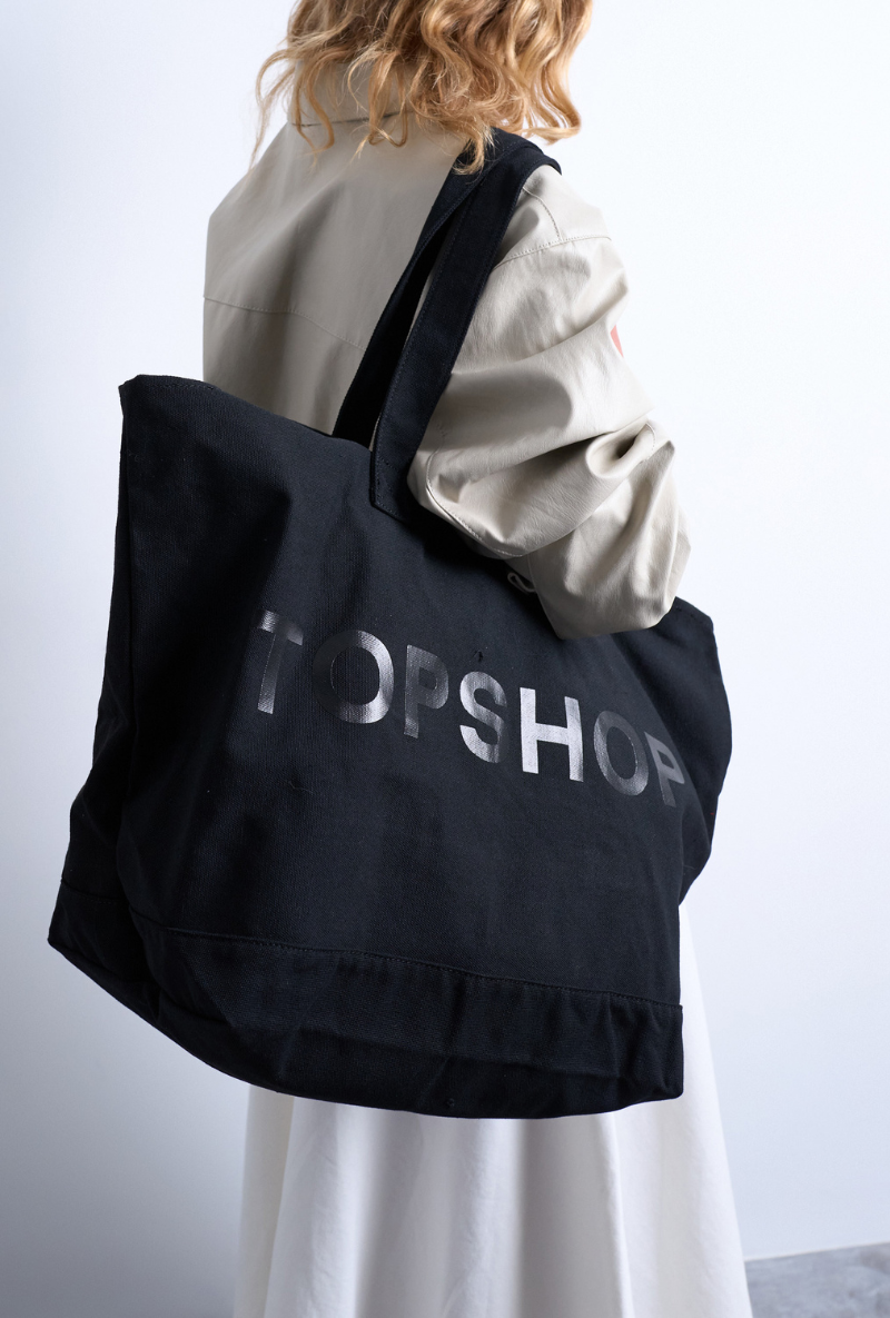 Back image of a model wearing Ivy tote bag in black, by brand Top shop