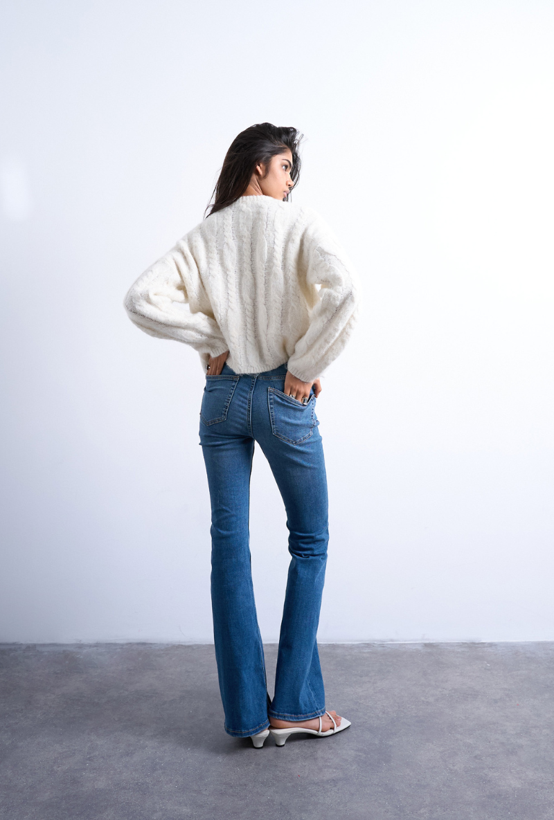Back image of a model wearing Jamie high rise flared jeans in denim, by brand Top shop