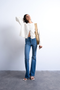 Front image of a model wearing Jamie high rise flared jeans in denim, by brand Top shop