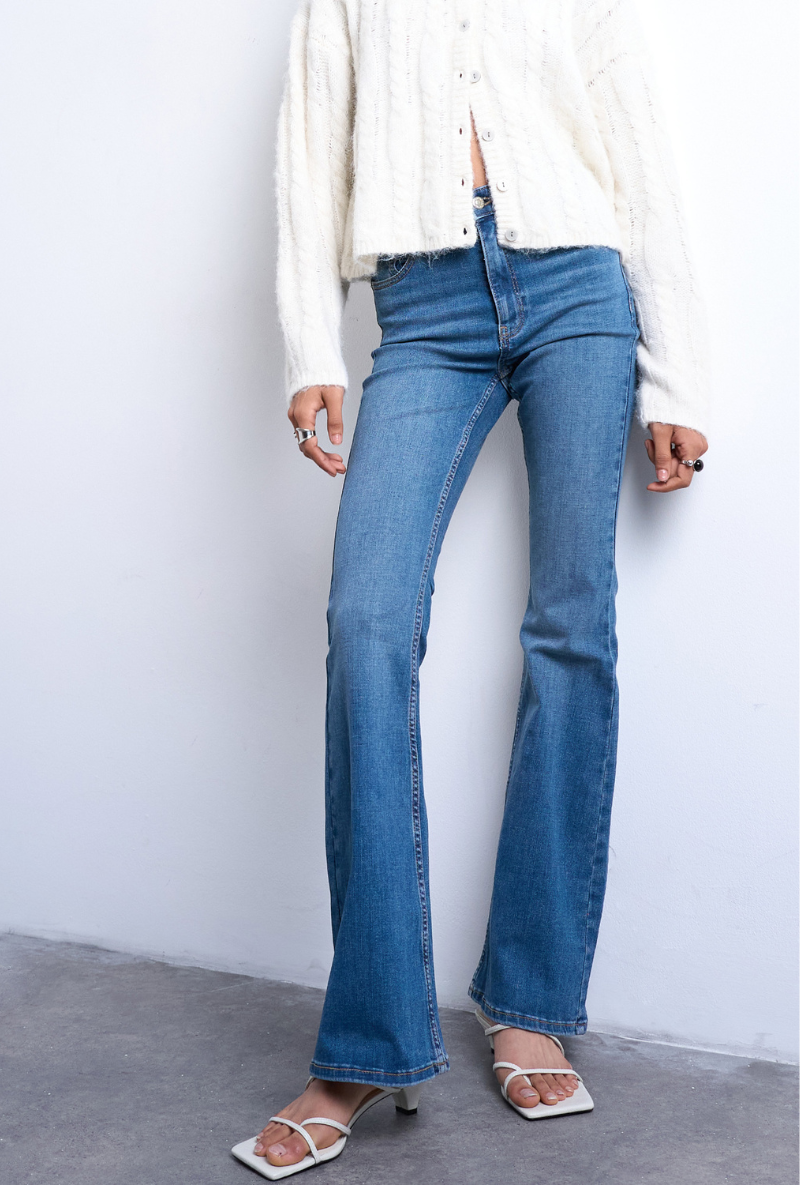 Front image of a model wearing Jamie high rise flared jeans in denim, by brand Top shop