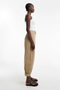 Front side image of a model wearing the Noor high rise cargo trousers in tan, by brand Top shop