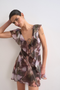 Front image of a model wearing the Rikke ruffle mini dress in brown, by brand Top shop