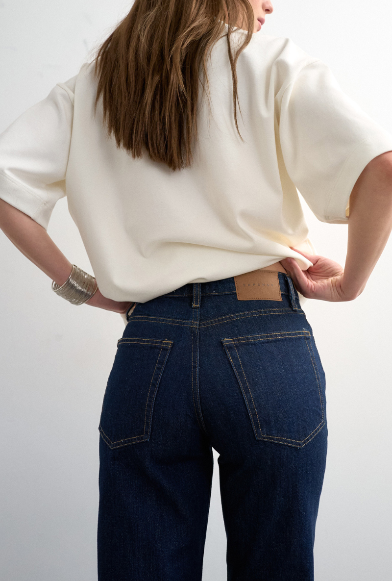 Back detail image of a model wearing Runway cropped jeans in dark denim, by brand Top shop