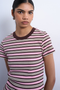 Front image of a model wearing the Sally stripe rib tee in pink, by brand Top shop