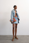 Front image of a model wearing Silje mini denim skirt in denim, by brand Top shop
