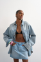 Front image of a model wearing the Silje mini denim skirt in denim, by brand Top shop