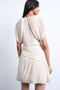 Back image of a model wearing the Svea drape mini dress in beige, by brand Top shop