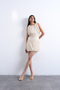 Front image of a model wearing Svea drape mini dress in beige, by brand Top shop