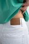 Back detail image of a model wearing the Vigga high rise white denim shorts in white, by brand Top shop