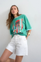 Front image of a model wearing the Vigga high rise white denim shorts in white, by brand Top shop