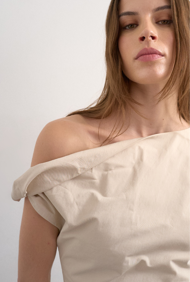 Front image of a model wearing Zenia mini dress in ecru, by brand Top shop