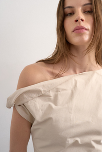 Front image of a model wearing the Zenia mini dress in ecru, by brand Top shop