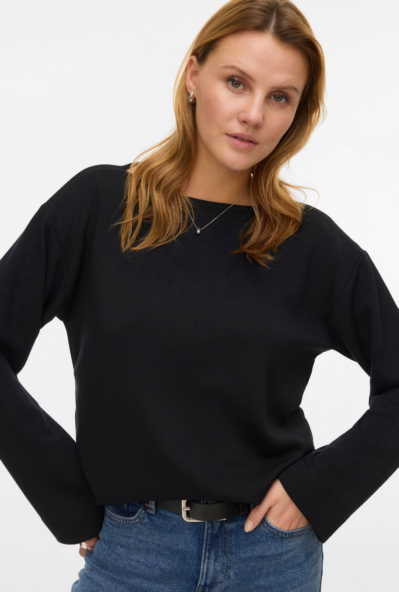 Front image of a model wearing Vero moda hali l/s boat neck top in black, by brand Vero moda