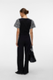 Back image of a model wearing the Jasy o neck top in black, by brand Vero moda