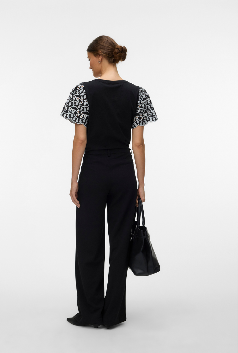 Back image of a model wearing Jasy o neck top in black, by brand Vero moda
